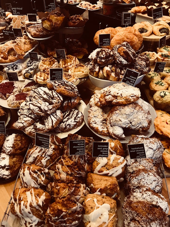 A mouthwatering selection of diverse pastries in a cozy bakery setting.